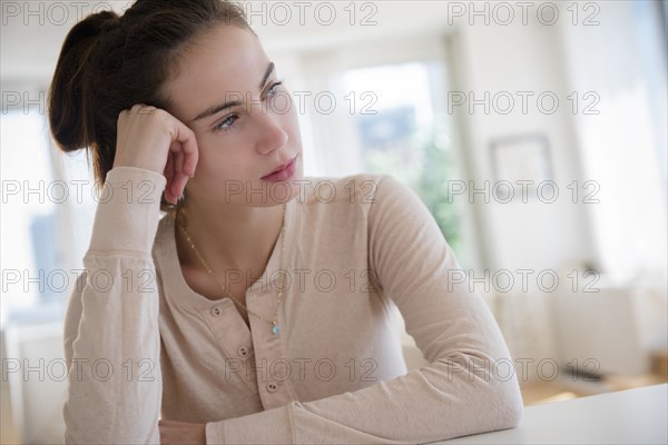 Sad Native American woman sitting at desk