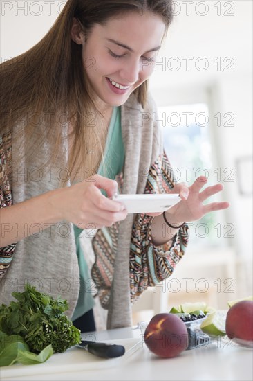 Native American woman photographing food