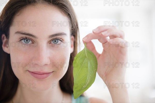 Native American woman holding leaf