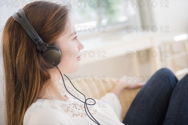 Native American woman listening to headphones