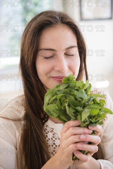 Native American woman smelling herbs