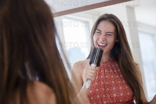 Native American woman singing with hairbrush