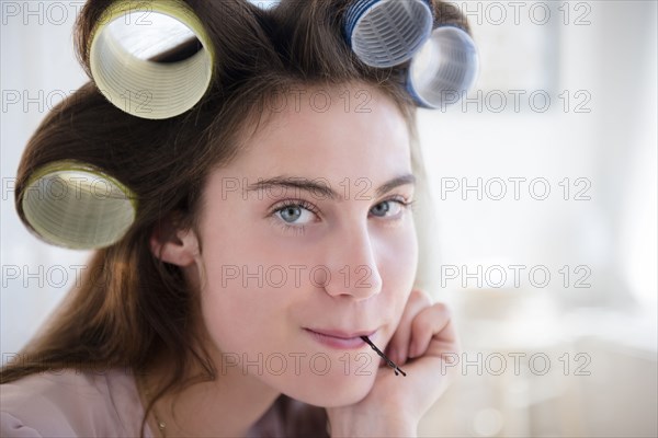 Native American woman with curlers in hair