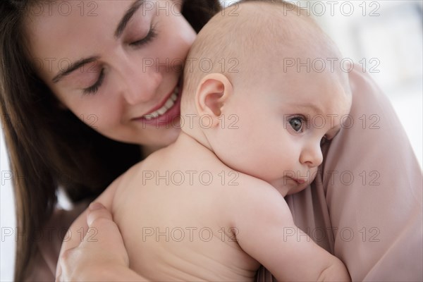 Close up of mother holding baby girl