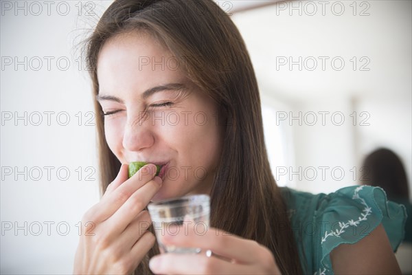 Native American woman drinking tequila shot