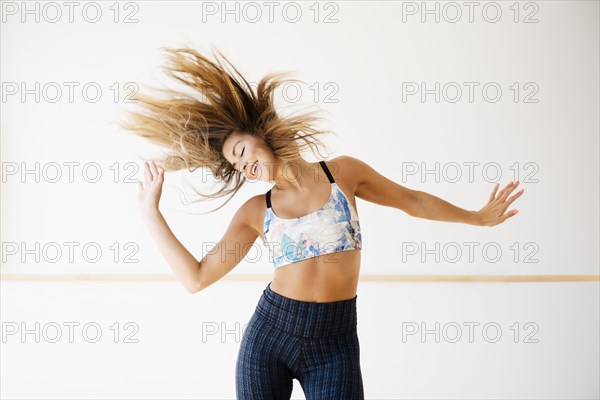 Mixed race dancer practicing in studio