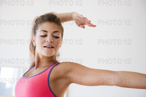 Mixed race dancer practicing in studio