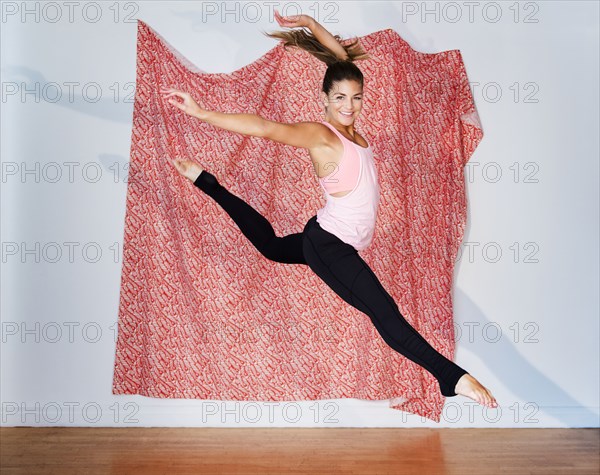 Mixed race dancer practicing in studio