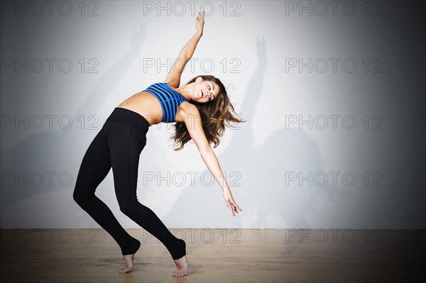 Mixed race dancer practicing in studio