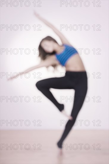 Mixed race dancer practicing in studio