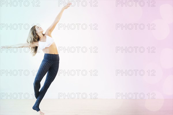 Mixed race dancer practicing in studio