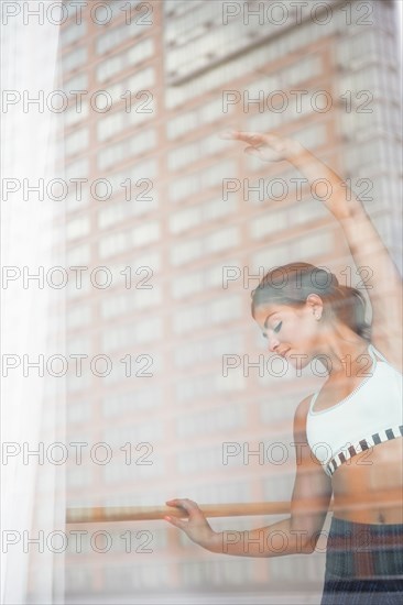 Mixed race dancer practicing in studio