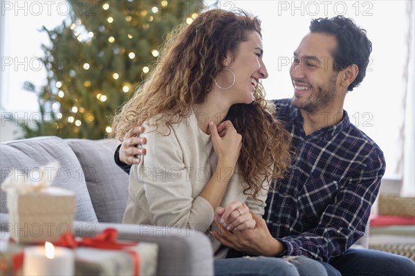 Couple hugging on sofa