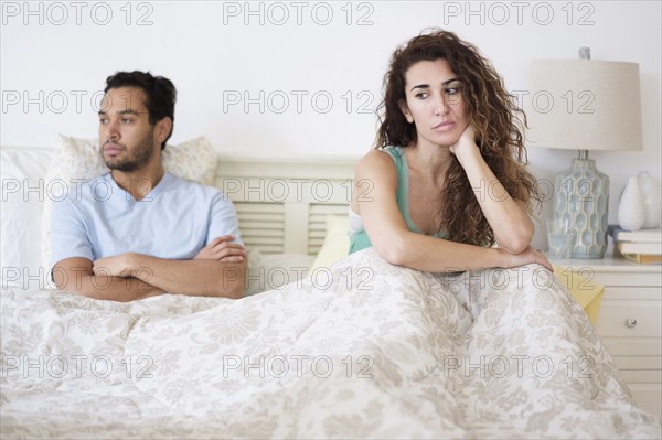 Couple arguing in bed