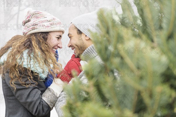 Couple hugging at Christmas tree farm