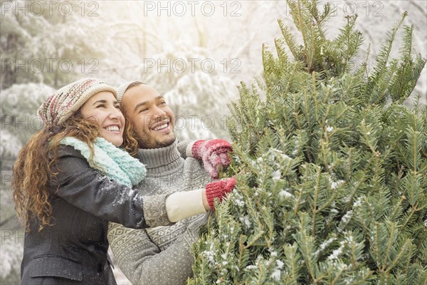 Couple hugging at Christmas tree farm