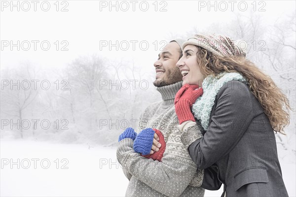 Couple hugging in snow