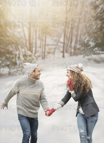 Couple holding hands in snow