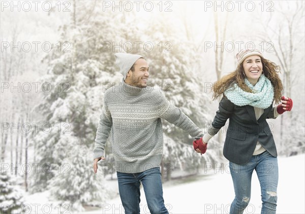 Couple holding hands in snow