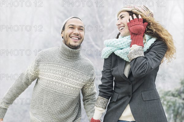 Couple holding hands in snow