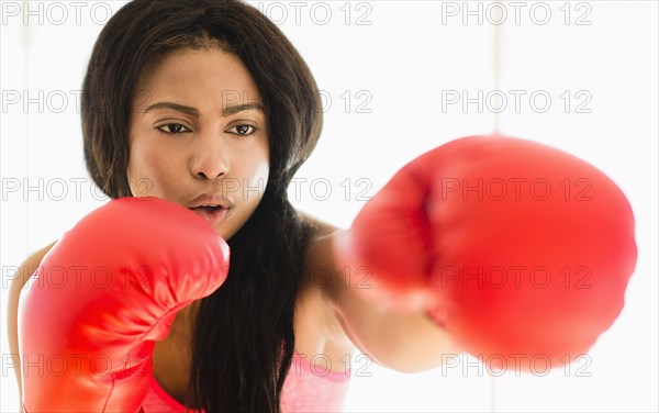 Mixed race boxer punching