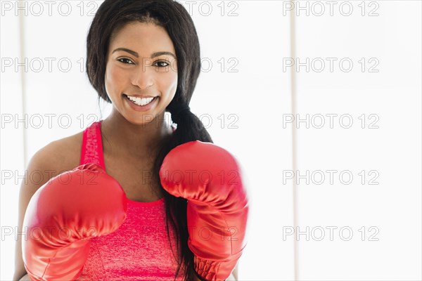 Mixed race boxer wearing boxing gloves
