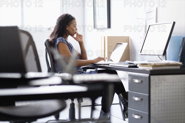 Mixed race businesswoman working in office