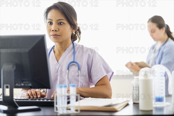 Nurse using computer in hospital