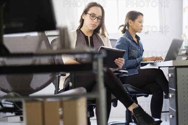 Businesswoman using digital tablet in office