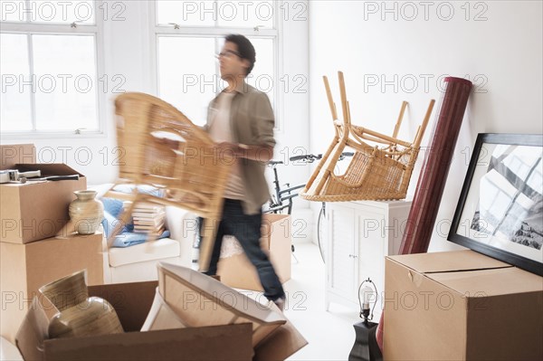 Mixed race man unpacking in new home