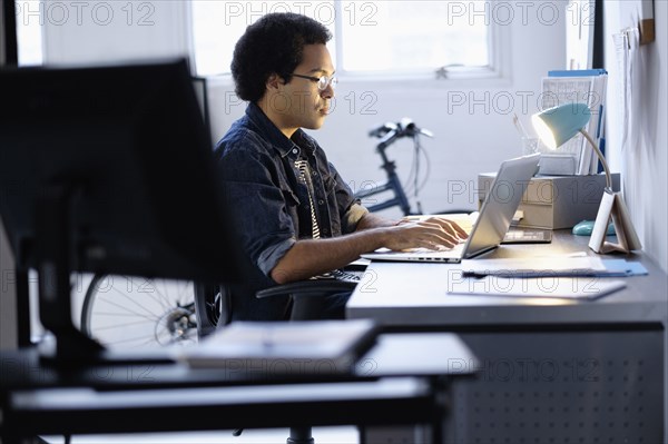 Mixed race businessman working in office