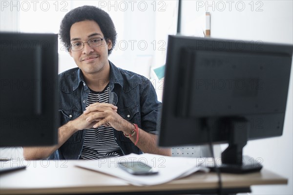 Mixed race businessman smiling in office