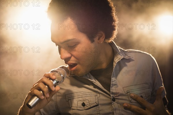 Mixed race singer performing on stage