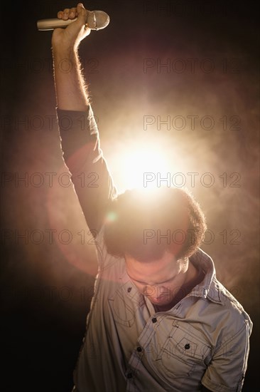 Mixed race singer performing on stage