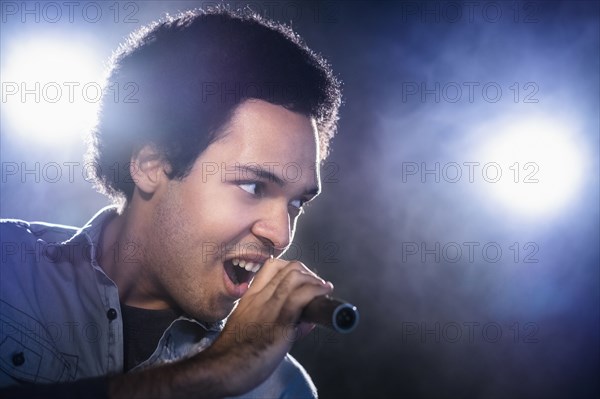 Mixed race singer performing on stage