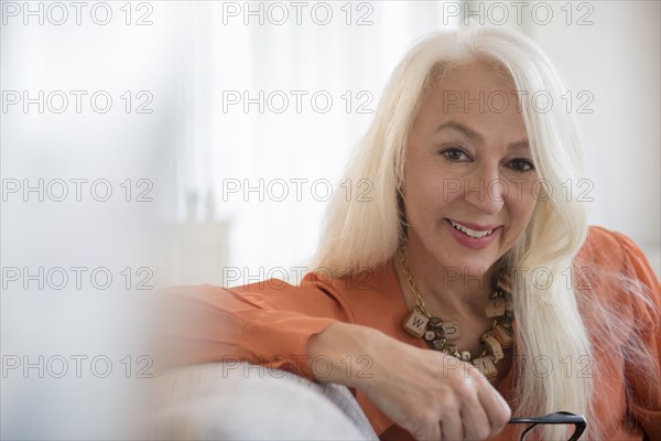 Caucasian woman smiling on sofa