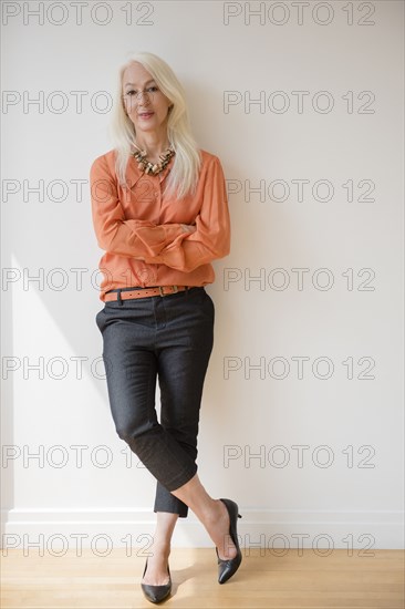 Caucasian businesswoman standing with arms crossed