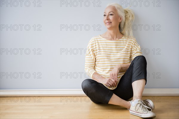 Caucasian woman sitting on floor