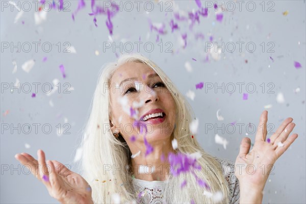 Caucasian woman throwing confetti