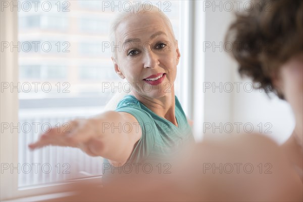 Women practicing yoga in class