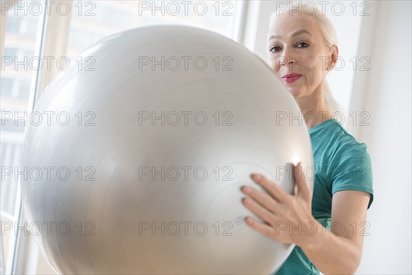 Caucasian woman holding fitness ball