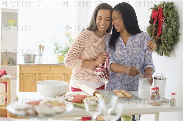 Mother and daughter baking in kitchen