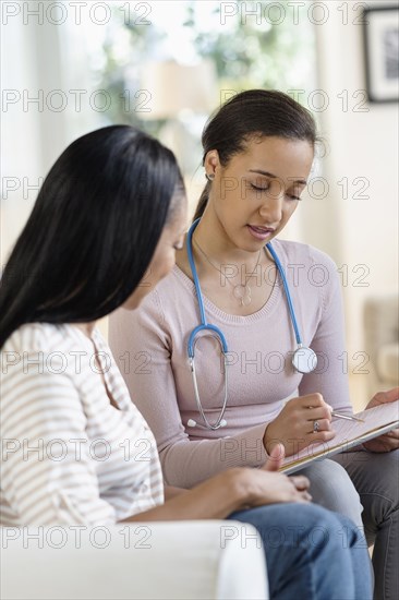 Doctor and patient talking in living room