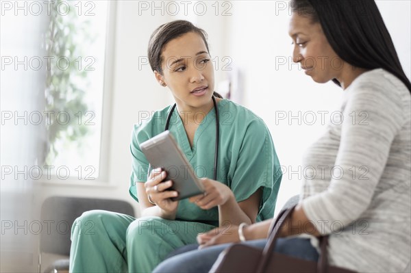 Nurse and patient using digital tablet