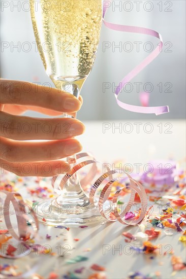 Hispanic woman holding glass of champagne