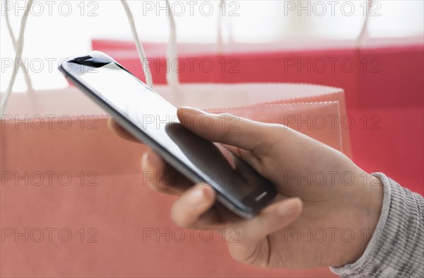 Hispanic woman holding cell phone