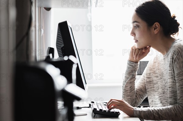 Hispanic woman using computer