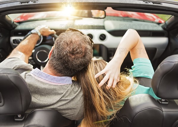 High angle view of Caucasian couple driving convertible