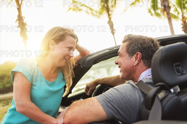 Caucasian talking in convertible