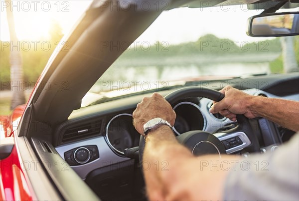 Caucasian man driving convertible